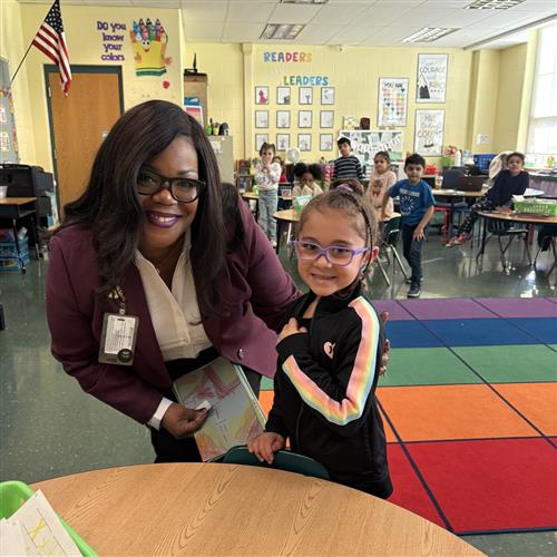 Dr. Natalyn Gibbs poses with a female student on one of Dr. Gibbs's first visits to EPS schools.